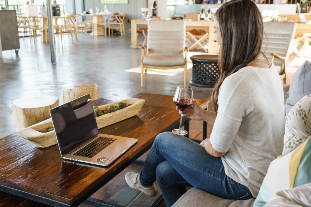 Woman with a glass of wine and laptop