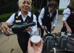 Woman pouring sparkling wine at Best Party Ever photo by Alexander Rubin