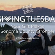 Sonoma County Vintners Foundation Your Gift Makes Sonoma County Stronger #TheProceedsMatter group of people with arms on each other's backs looking over mountains and fog