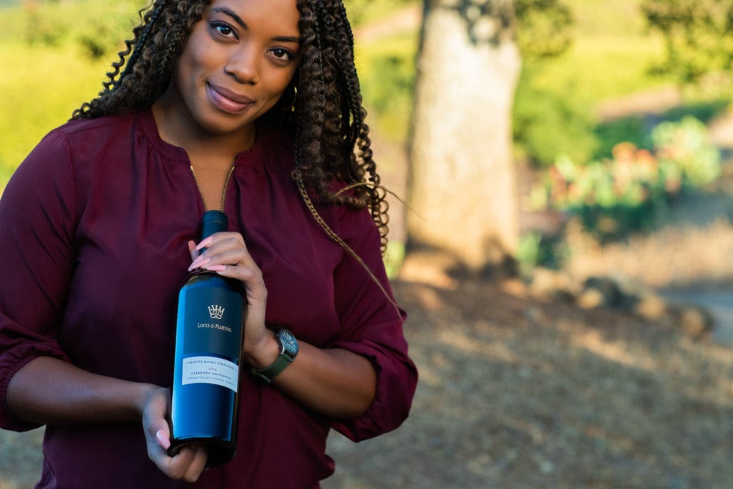 Sonoma County Winery employee holding a bottle of wine
