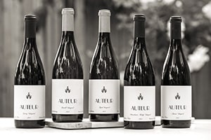 Auteur Wines five bottles lined up in black and white