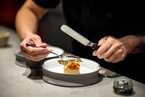 Close up of chef plating a dish