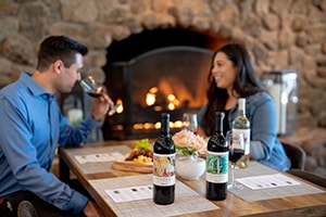 Couple tasting wine at a table